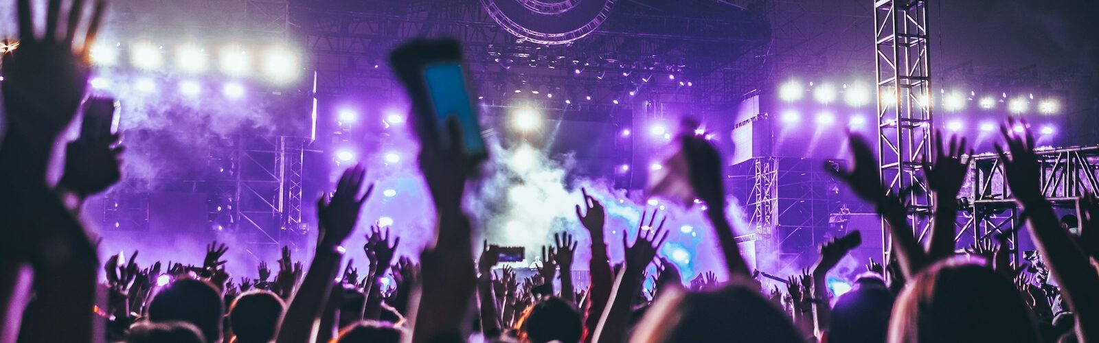 group of people raising there hands in concert