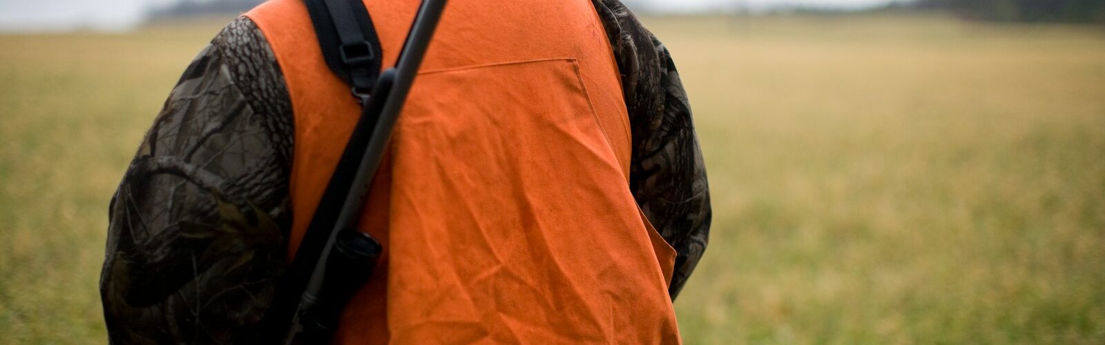 man in orange and black backpack