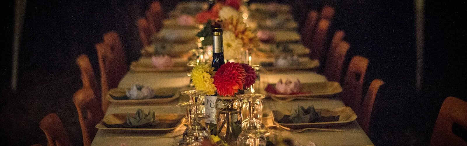 white and green ceramic plates on brown wooden dining table