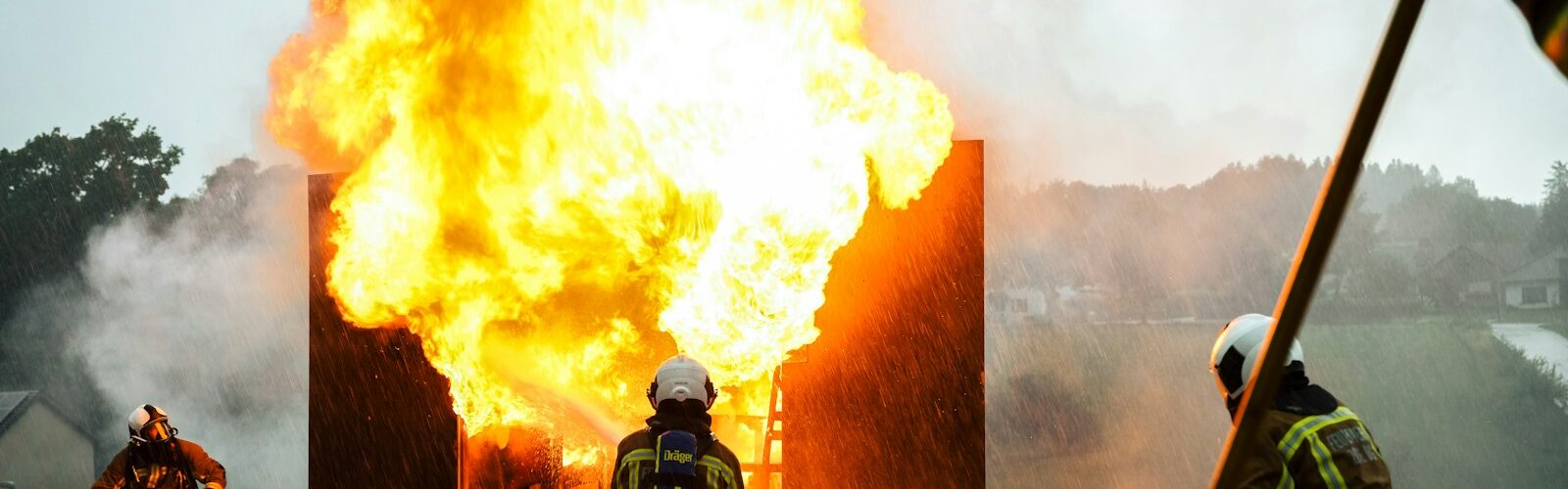 a group of fire fighters standing around a fire