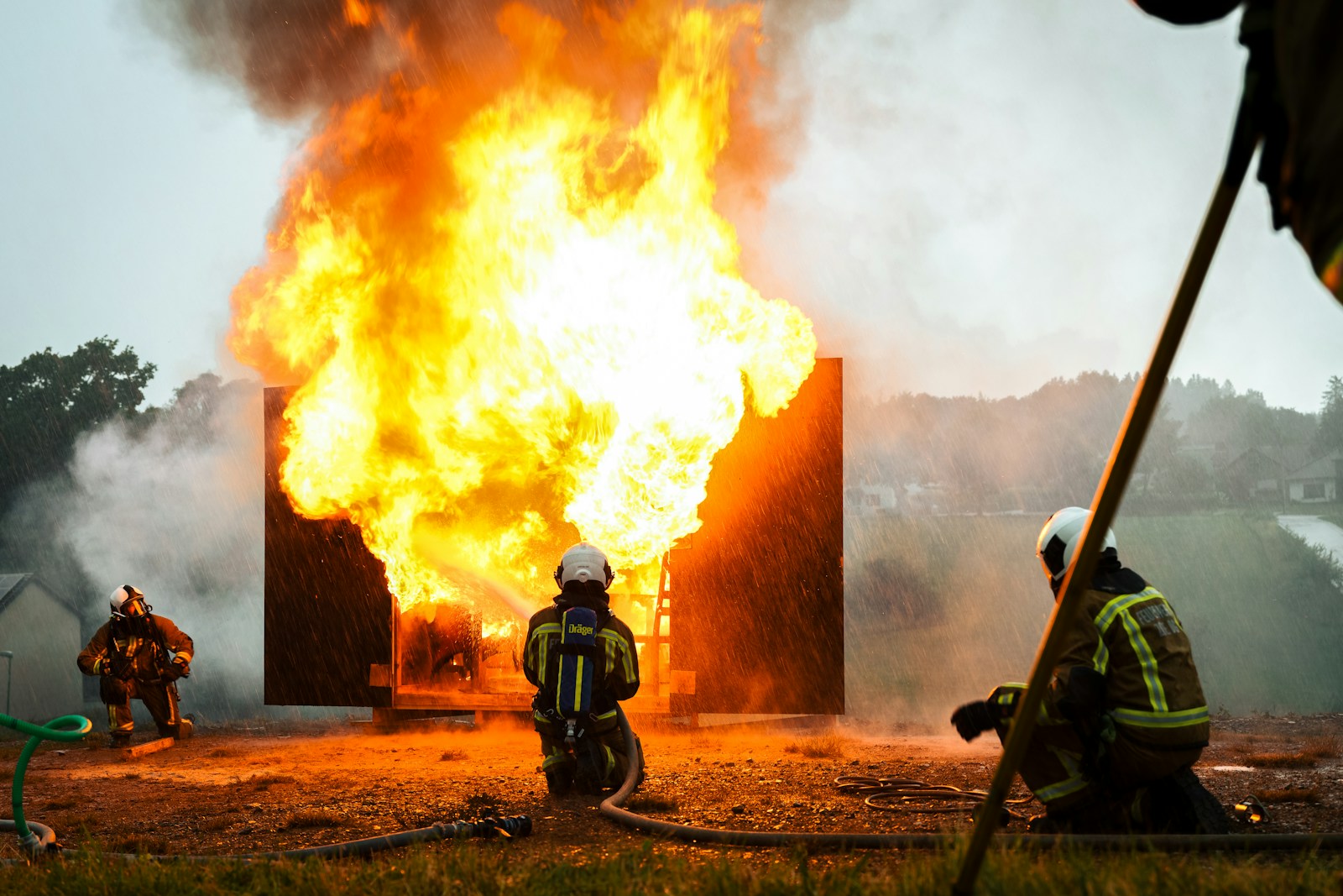 a group of fire fighters standing around a fire